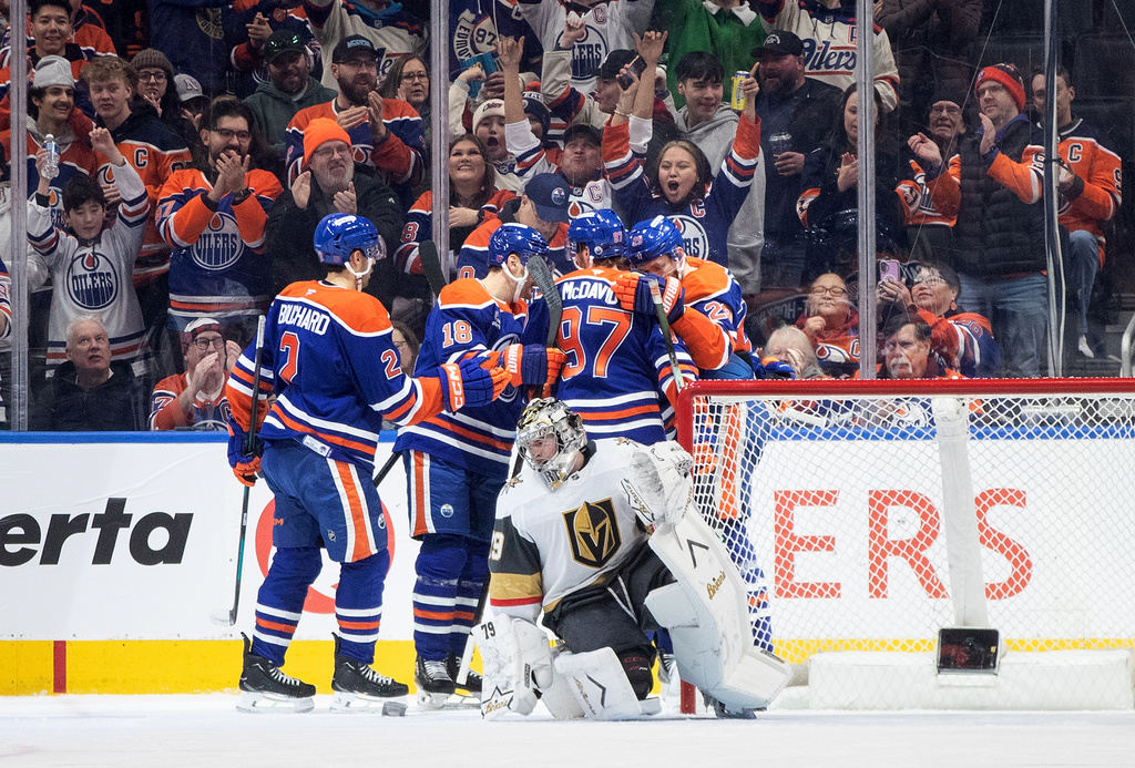 Vegas Golden Knights goalie Carter Hart (79) looks on as the Edmonton Oilers celebrate a goal during the first period of an NHL hockey game, in Edmonton, Alberta, Sunday, Dec. 21, 2025. (Jason Franson/The Canadian Press via AP)