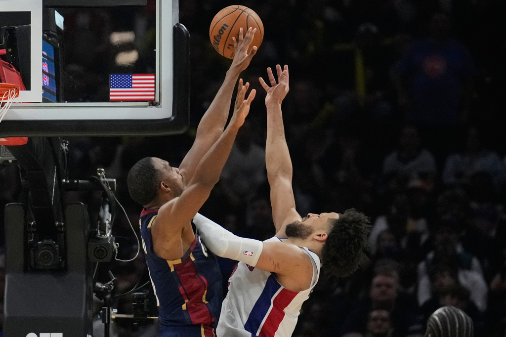 Detroit Pistons guard Cade Cunningham, right, shoots past Cleveland Cavaliers center Evan Mobley, left, in the second half of Game 6 of a second-round NBA basketball playoffs series Friday, May 15, 2026, in Cleveland. (AP Photo/Sue Ogrocki)