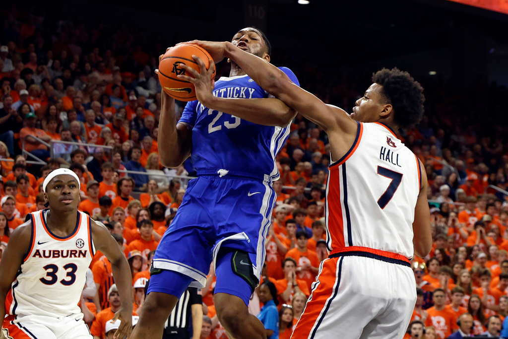 Auburn guard Keyshawn Hall (7) blocks the shot of Kentucky forward Mouhamed Dioubate (23) during the first half of an NCAA college basketball game Saturday, Feb. 21, 2026, in Auburn, Ala. (AP Photo/Butch Dill)