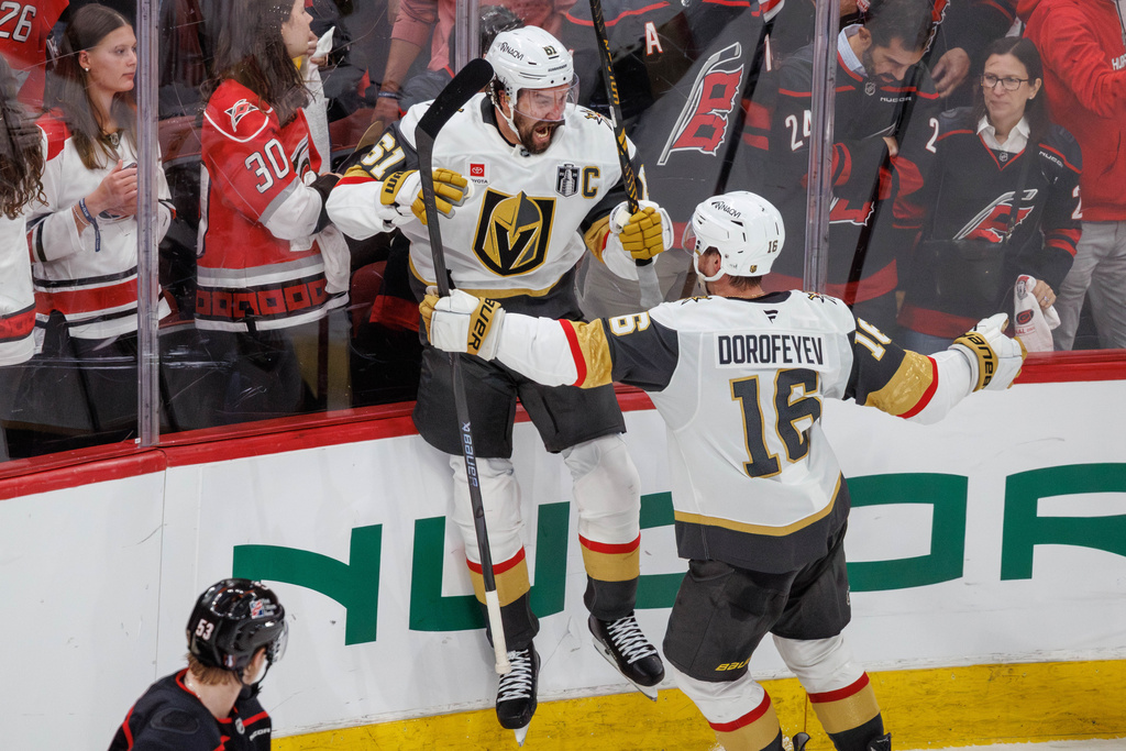 Vegas Golden Knights' Mark Stone (61) celebrates with Pavel Dorofeyev (16) after scoring against the Carolina Hurricanes to tie in the third period of Game 2 of the NHL hockey Stanley Cup Final series in Raleigh, N.C., Thursday, June 4, 2026. (AP Photo/Ben McKeown)