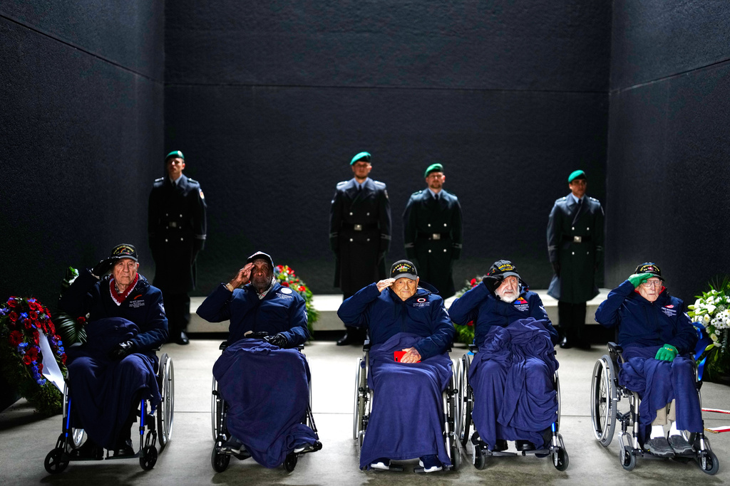 United States World War II veterans, from left, PFC Hilbert Margol of the Battery B 392nd Field Artillery Battalion 42nd Infantry Division, Lt. Col. Enoch Woodhouse of the 332nd Fighter Group 15th Air Force, Col. Frank Arthur Athanason of the 178th 3rd Replacement Depot, Pat Gideon Kantor of the 3804th Quartermaster Truck Company and Pfc. Fred J. Nungesser of the M Company 334th Infantry Regiment 84th Infantry Division salute after a wreath laying ceremony at the German Defence Ministry in Berlin, Germany, Monday, Nov. 10, 2025. (AP Photo/Markus Schreiber)