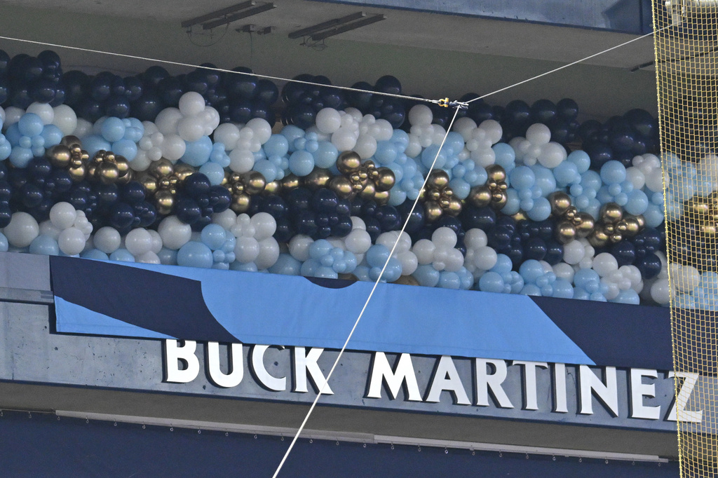Buck Martinez, former Toronto Blue Jays player, manager and broadcaster's name is revealed as he is inducted into the team's new Hall of Excellence in an on-field ceremony before a baseball game against the Seattle Mariners in Toronto, Saturday, Aug. 29, 2026. (Jon Blacker/The Canadian Press via AP)