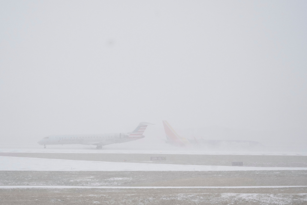 Planes move on the tarmac at the Nashville International Airport during a winter storm Saturday, Jan. 24, 2026, in Nashville, Tenn. (AP Photo/George Walker IV)