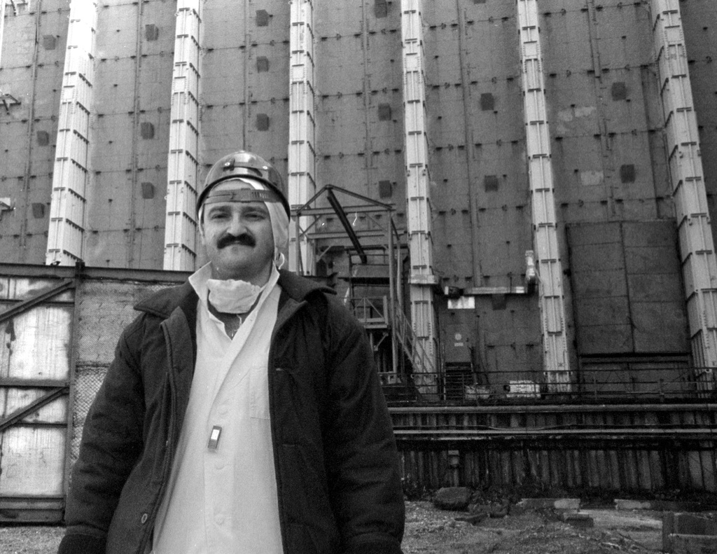 FILE - Efrem Lukatsky, now an Associated Press photographer, wears protective clothes outside the sarcophagus that covers destroyed Reactor No. 4 in the Chernobyl nuclear power plant in Chernobyl, Ukraine, in this undated photo taken several years after the explosion. (AP Photo, File)