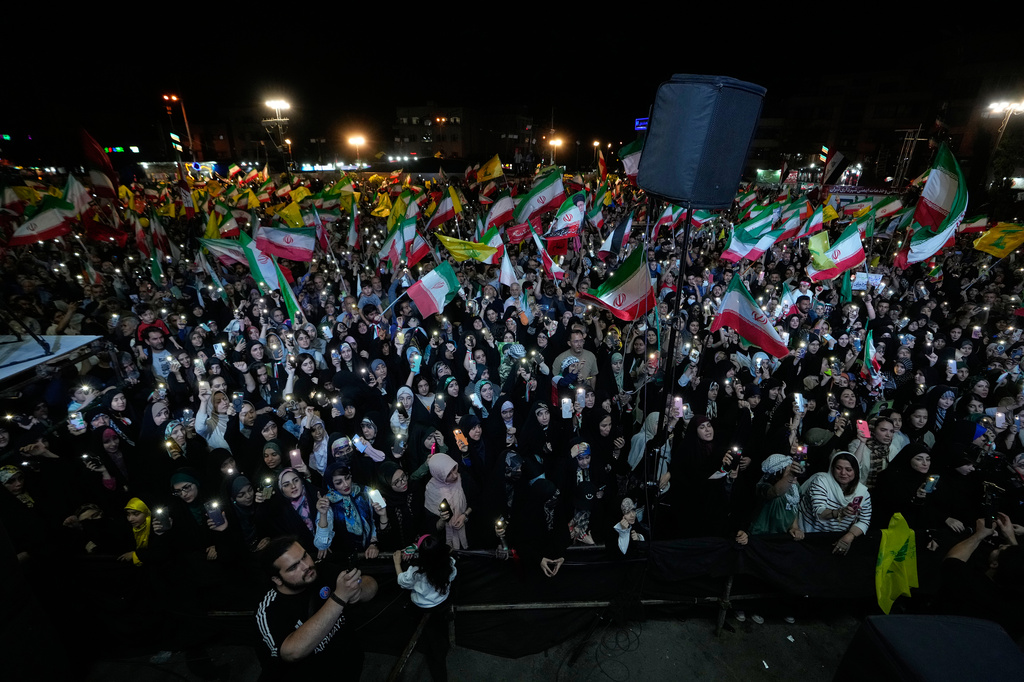 Demonstrators wave Iranian flags and flags of Lebanon's militant Hezbollah group during a pro-government gathering at Islamic Revolution Square in Tehran, Iran, Saturday, May 30, 2026. (AP Photo/Vahid Salemi)