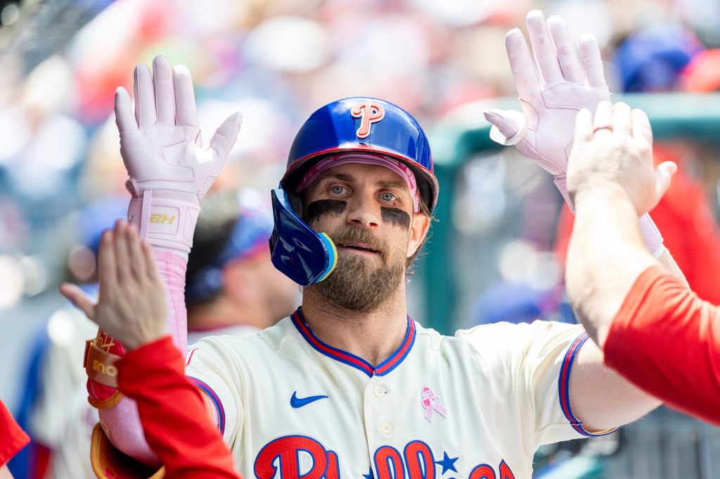 Philadelphia Phillies' Bryce Harper is congratulated in the dugout after he hit a solo home run in the first inning of a baseball game against the Colorado Rockies, Sunday, May 10, 2026, in Philadelphia. (AP Photo/Laurence Kesterson)