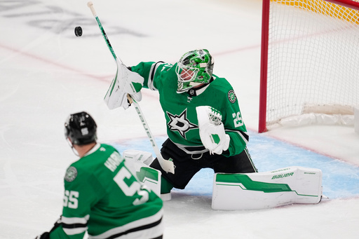 Dallas Stars goaltender Jake Oettinger (29) blocks a shot as Thomas Harley (55) looks on in the first period of an NHL hockey game against the Washington Capitals Tuesday, Oct. 28, 2025, in Dallas. (AP Photo/Tony Gutierrez) Dallas Stars goaltender Jake Oettinger (29) blocks a shot as Thomas Harley (55) looks on in the first period of an NHL hockey game against the Washington Capitals Tuesday, Oct. 28, 2025, in Dallas. (AP Photo/Tony Gutierrez)