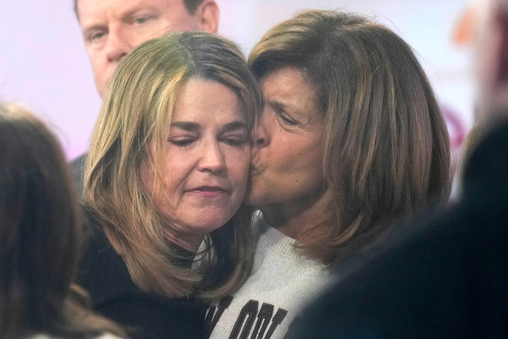 Savannah Guthrie, left, gets a kiss form Hoda Kotb during a visit to the Today show at Rockefeller Plaza on Thursday, March 5, 2026, in New York. (Photo by Charles Sykes/Invision/AP)