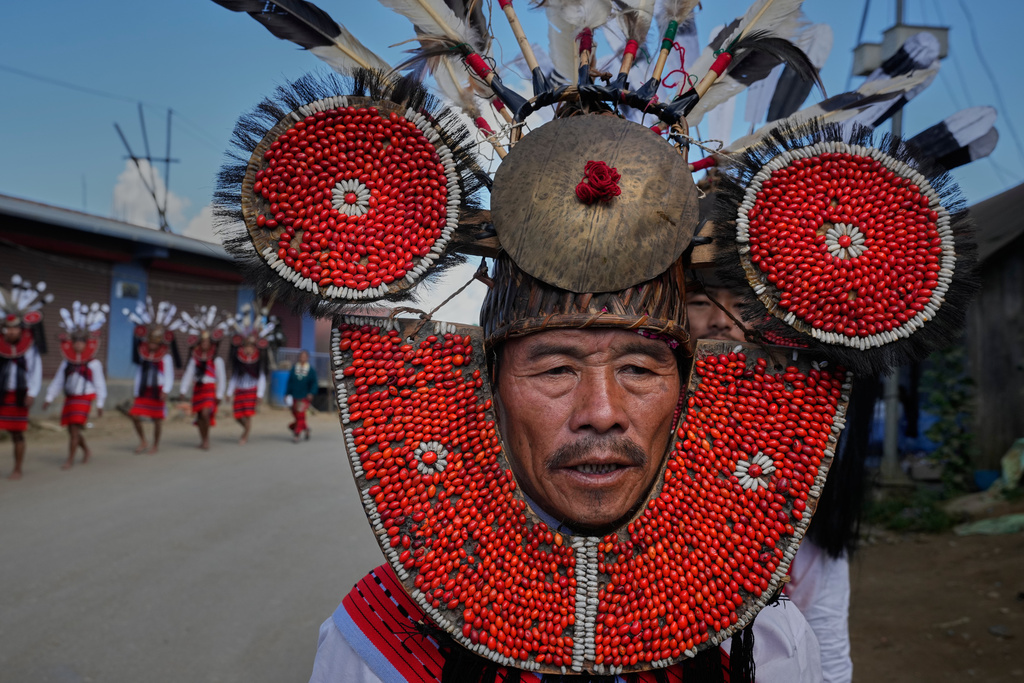 A Naga, dressed in traditional attire, waits for the arrival of Thuingaleng Muivah, leader of the National Socialist Council of Nagaland (Isak-Muivah), in Ukhrul, in the northeastern Indian state of Manipur, Wednesday, Oct. 22, 2025. (AP Photo/Anupam Nath)