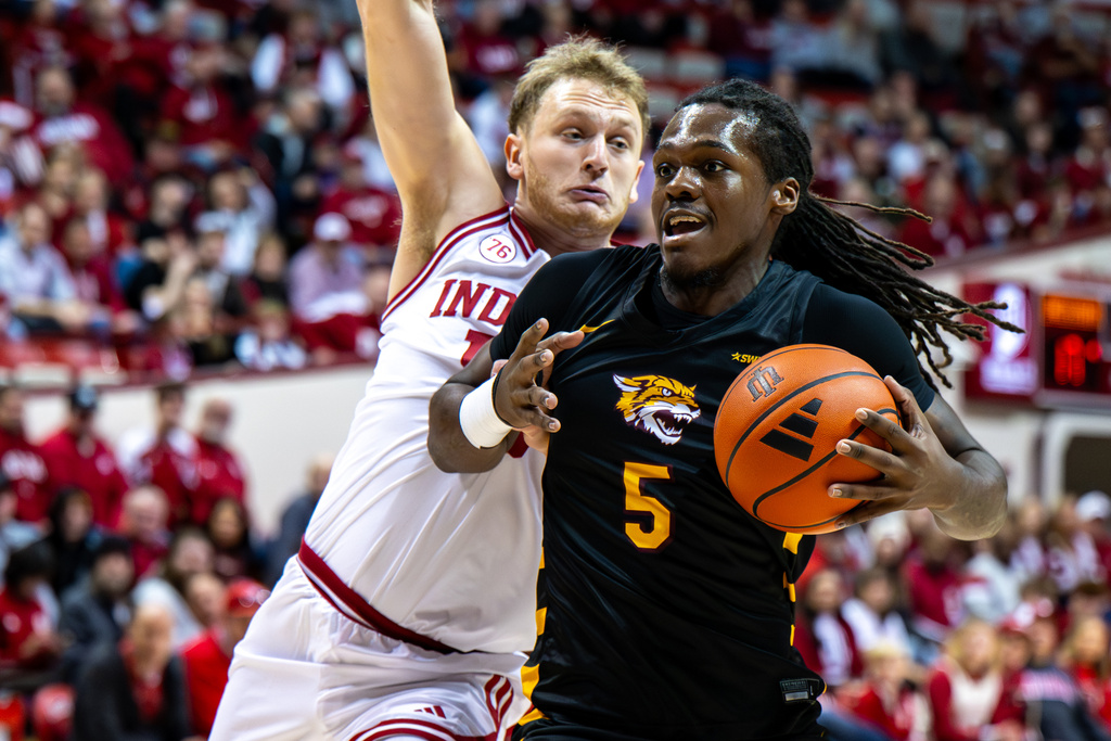 Bethune-Cookman forward Quentin Heady (5) is defended by Indiana forward Tucker Devries (12) during the first half of an NCAA college basketball game, Saturday, Nov. 29, 2025, in Bloomington, Ind. (AP Photo/Doug McSchooler)