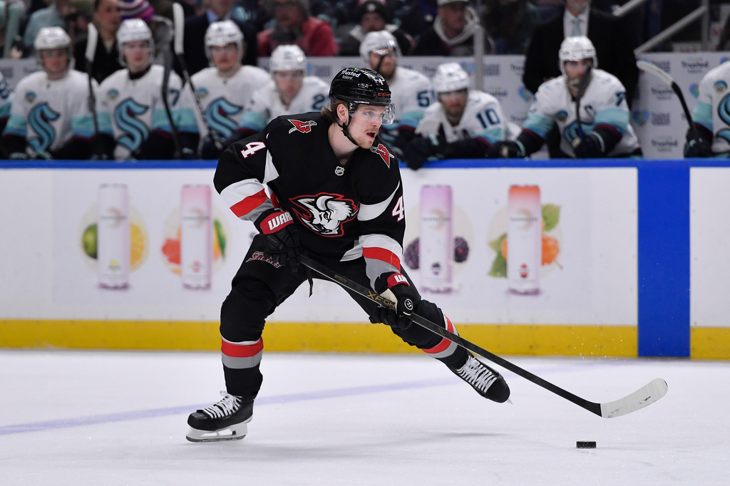 Buffalo Sabres defenseman Bowen Byram (4) skates with the puck during the first period of an NHL hockey game against the Seattle Kraken, Saturday, March 28, 2026, in Buffalo, N.Y. (AP Photo/Adrian Kraus)