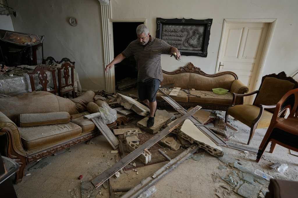 Lebanese Rida Hijazi checks his house damaged in an Israeli airstrike on Thursday, in the city of Tyre, southern Lebanon, Saturday, April 18, 2026. (AP Photo/Bilal Hussein)