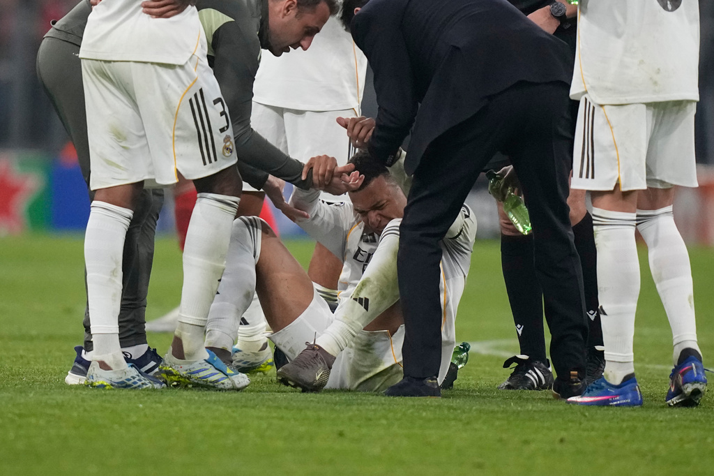 Real Madrid's Kylian Mbappe lies on the pitch after injuring during the Champions League quarterfinal second leg soccer match between Bayern Munich and Real Madrid in Munich, Germany, Wednesday, April 15, 2026. (AP Photo/Matthias Schrader)