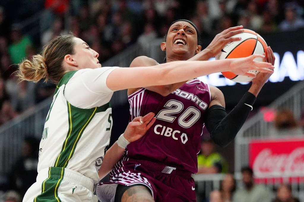 Seattle Storm forward Katie Lou Samuelson (33) fouls Toronto Tempo guard Brittney Sykes (20) on her way to the net during the second half of a WNBA basketball game in Toronto, Saturday, May 30, 2026. (Frank Gunn/The Canadian Press via AP)