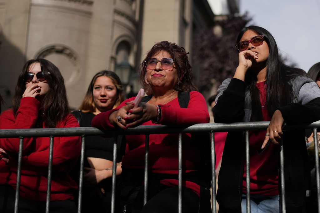 Supporters react to preliminary results at the campaign headquarters of Jeannette Jara, presidential candidate of the ruling Unity for Chile coalition, after polls closed for the presidential runoff in Santiago, Chile, Sunday, Dec. 14, 2025. (AP Photo/Natacha Pisarenko)