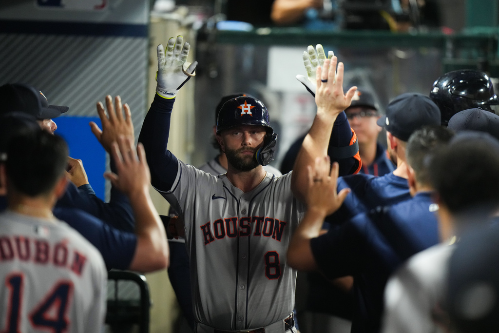Houston Astros' Christian Walker (8) celebrates his home run with teammates during the fourth inning of a baseball game against the Los Angeles Angels Saturday, Sept. 27, 2025, in Anaheim, Calif. (AP Photo/Jae C. Hong)