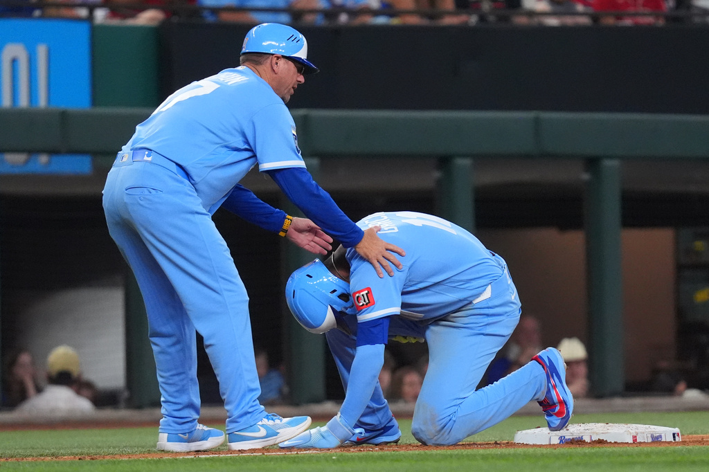 Kansas City Royals' Maikel Garcia, right, is aided by third base coach Vance Wilson, left, after he was injured during the seventh inning of a baseball game against the Texas Rangers, Saturday, May 30, 2026, in Arlington, Texas. (AP Photo/LM Otero)