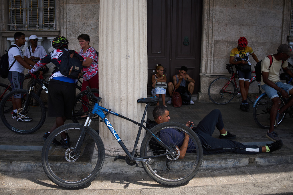 People wait for the arrival of a public bus to transport their bicycles across the Bay Tunnel in Havana, Wednesday, April 8, 2026. (AP Photo/Ramon Espinosa)