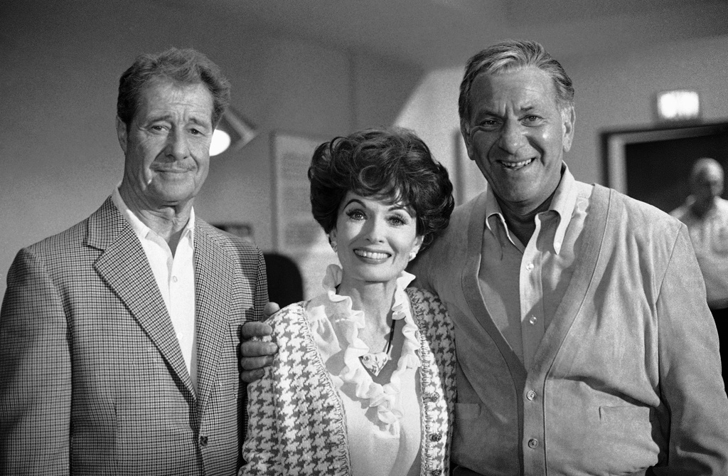 FILE - Don Ameche, left, and Ann Blyth, center, as guest stars, join Jack Klugman on the set for an episode of the television series, Quincy, June 22, 1978, Los Angeles, Calif. (AP Photo/Nick Ut, File)