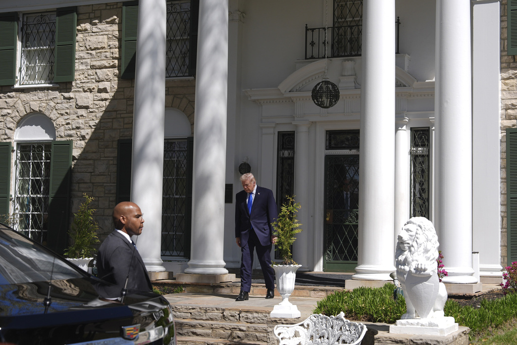 President Donald Trump walks out of Graceland, Elvis Presley's historic estate, after touring, Monday, March 23, 2026, in Memphis, Tenn. (AP Photo/Mark Schiefelbein)