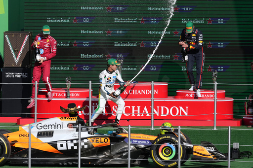McLaren driver Lando Norris of Britain celebrates on the podium with Red Bull driver Max Verstappen of the Netherlands, right, and Ferrari driver Charles Leclerc of Monaco after wining the Formula One Mexico Grand Prix in Mexico City, Sunday, Oct. 26, 2025. (AP Photo/Eduardo Verdugo) McLaren driver Lando Norris of Britain celebrates on the podium with Red Bull driver Max Verstappen of the Netherlands, right, and Ferrari driver Charles Leclerc of Monaco after wining the Formula One Mexico Grand Prix in Mexico City, Sunday, Oct. 26, 2025. (AP Photo/Eduardo Verdugo)