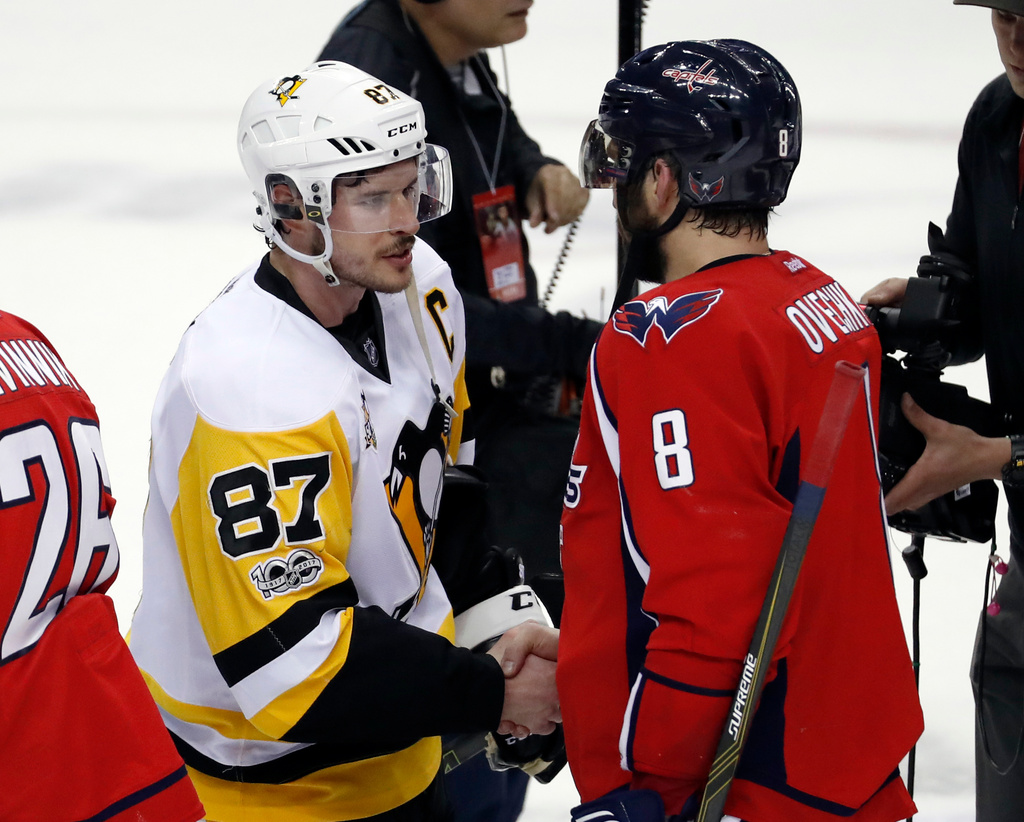 FILE - Washington Capitals left wing Alex Ovechkin (8), from Russia, talks with Pittsburgh Penguins center Sidney Crosby (87) after Game 7 in an NHL hockey Stanley Cup Eastern Conference semifinal, Wednesday, May 10, 2017, in Washington. (AP Photo/Alex Brandon, File)