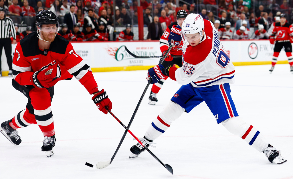 Montréal Canadiens right wing Ivan Demidov (93) shoots against New Jersey Devils defenseman Dougie Hamilton (7) during the first period of an NHL hockey game, Saturday, April 4, 2026, in Newark, N.J. (AP Photo/Noah K. Murray)