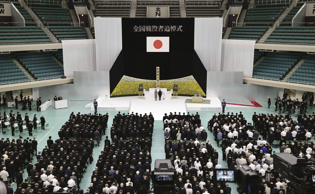 FILE - Japan's Emperor Naruhito, rear right, and Empress Masako, rear left, observe a moment of silence during a memorial service for the war dead at the Nippon Budokan hall in Tokyo, as the country marks the 79th anniversary of its defeat in the World War II, on Aug. 15, 2024. (Kyodo News via AP, File)