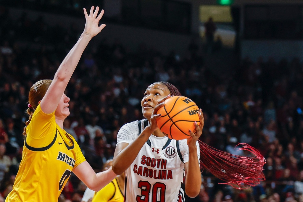 South Carolina forward Maryam Dauda (30) looks to shoot against Missouri guard Grace Slaughter, left, during the first half of an NCAA college basketball game in Columbia, S.C., Thursday, Feb. 26, 2026. (AP Photo/Nell Redmond)