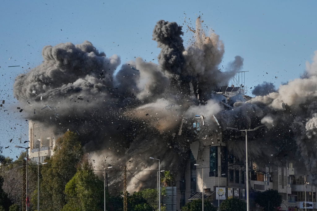 Smoke rises after an Israeli airstrike hits a building near the airport road in Beirut, Lebanon, Tuesday, March 31, 2026. (AP Photo/Hussein Malla)