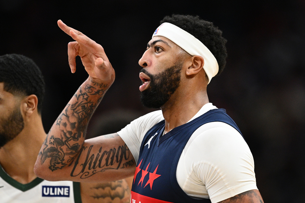 Washington Wizards forward/center Anthony Davis gestures after he made a basket during the first half of an NBA basketball game against the Milwaukee Bucks, Wednesday, Oct. 21, 2026, in Washington. (AP Photo/Nick Wass)