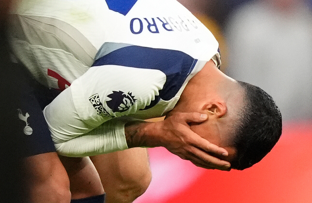 Tottenham Hotspur's Pedro Porro appears dejected after the final whistle of an English Premier League soccer match between Tottenham Hotspur and Brighton and Hove Albion, Saturday, April 18, 2026, in London. (Jordan Pettitt/PA via AP)