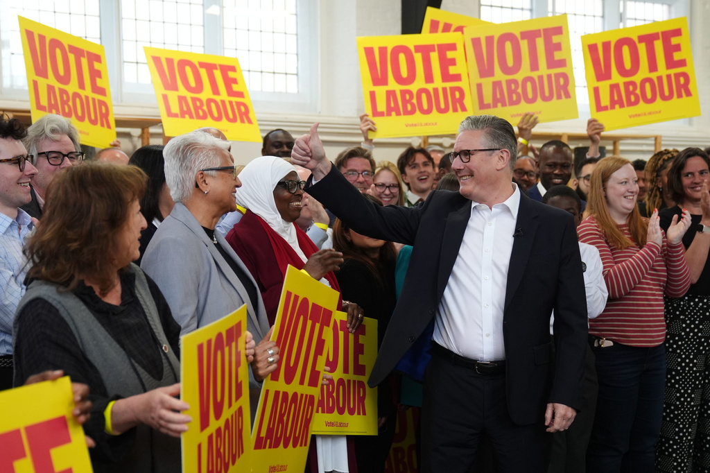 Britain's Prime Minister Keir Starmer gestures to supporters during a visit to All Saints Hall in south London, Tuesday May 5, 2026, whilst campaigning for the upcoming local elections. (Ben Whitley/PA via AP)