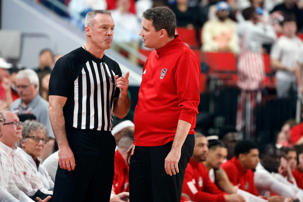 North Carolina State head coach Will Wade, right, talks with an official during the first half of an NCAA college basketball game against Duke in Raleigh, N.C., Monday, March 2, 2026. (AP Photo/Karl DeBlaker)