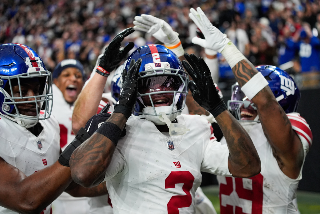 New York Giants cornerback Deonte Banks (2) celebrates his touchdown with teammates during the second half of an NFL football game against the Las Vegas Raiders Sunday, Dec. 28, 2025, in Las Vegas. (AP Photo/John Locher)