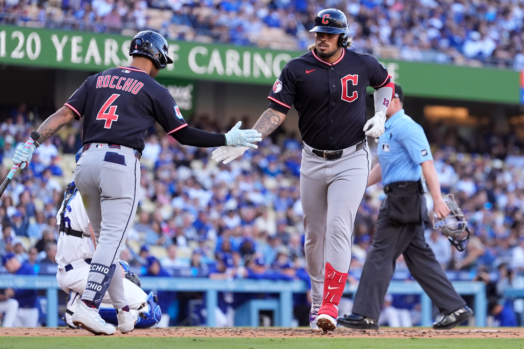Cleveland Guardians' Gabriel Arias, right, is congratulated by Brayan Rocchio after hitting a solo home run during the third inning of a baseball game against the Los Angeles Dodgers, Wednesday, April 1, 2026, in Los Angeles. (AP Photo/Mark J. Terrill)