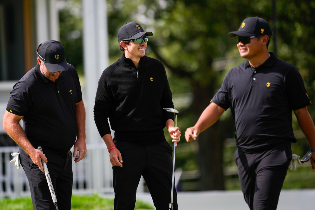 From left: International teams' Ryan Fox, of New Zealand, Nico Echavarria, of Columbia, and Ryo Hisatsune, of Japan, practice on the 14th hole prior to the start of the Presidents Cup golf tournament against the USA team at Medinah Country Club, Wednesday, Sept. 23, 2026, in Medinah, Ill. (AP Photo/Matt Slocum)
