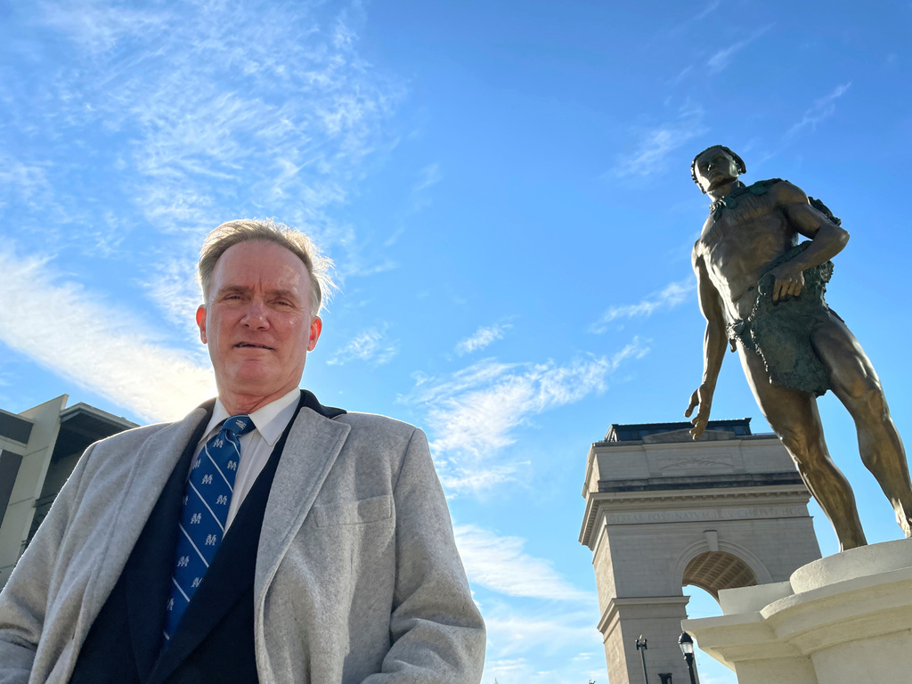 FILE - Developer Rodney Mims Cook Jr. stands next to the statue of Chief Tomochichi he commissioned for Atlanta's Peace Park, temporarily installed outside his Millennium Gate Museum, on Jan. 26, 2022. (AP Photo/Michael Warren, File)