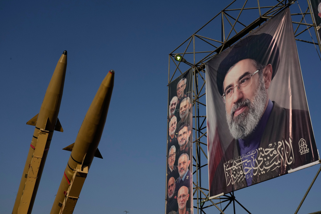 Iranian missiles and banners showing portraits of the Iranian Supreme Leader Ayatollah Mojtaba Khamenei, right, and the late armed forces commanders, who were killed in Israeli and U.S. strikes, are displayed in a military exhibition commemorating the anniversary of the start of the 1980-88 Iraq-Iran war at Baharestan Square, in Tehran, Monday, Sept. 28, 2026. (AP Photo/Vahid Salemi)