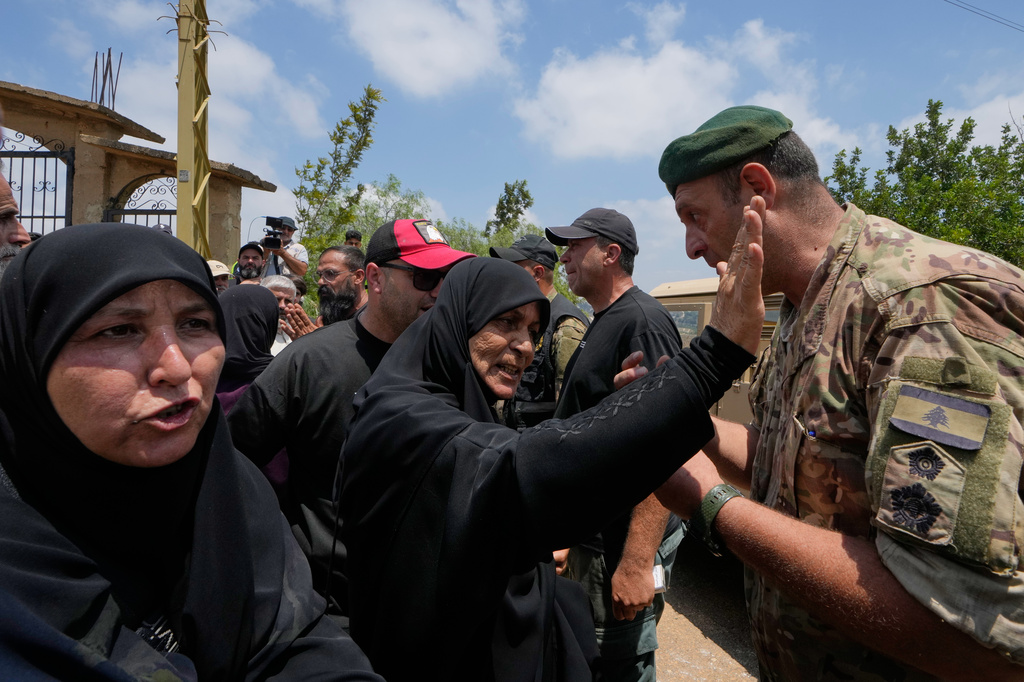 Lebanese army soldiers prevent residents from entering the southern village of Zawtar al-Gharbiyeh while deploying at the village entrance, Lebanon, Wednesday, July 22, 2026. (AP Photo/Mohammed Zaatari)