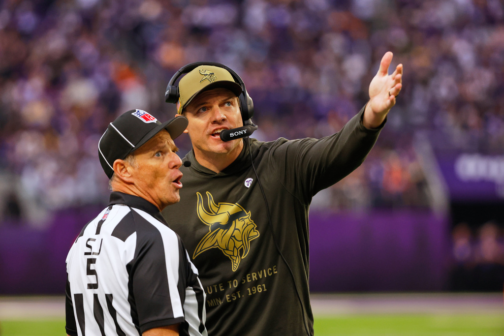 Minnesota Vikings head coach Kevin O'Connell talks to side judge Jim Quirk (5) in the second half of an NFL football game against the Baltimore Ravens, Sunday, Nov. 9, 2025, in Minneapolis. (AP Photo/Bruce Kluckhohn)