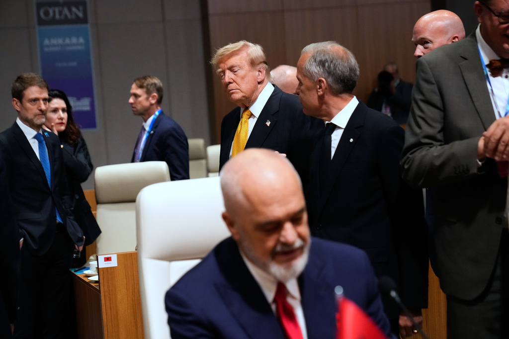 President Donald Trump, center left, speaks with Canada's Prime Minister Mark Carney, center right, prior to a round table meeting of the North Atlantic Council during the NATO summit in Ankara, Turkey, Wednesday, July 8, 2026. (AP Photo/Hussein Malla)