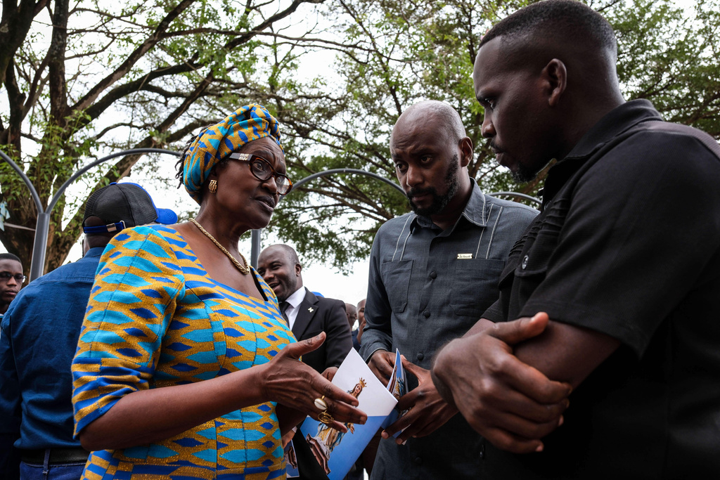 Winnie Byanyima, left, UNAIDS chief and wife of detained Ugandan opposition figure Kizza Besigye, talks with leaders during a prayer for him at Rubaga Cathedral in Kampala, Monday, Feb. 23, 2026. (AP Photo/Hajarah Nalwadda)