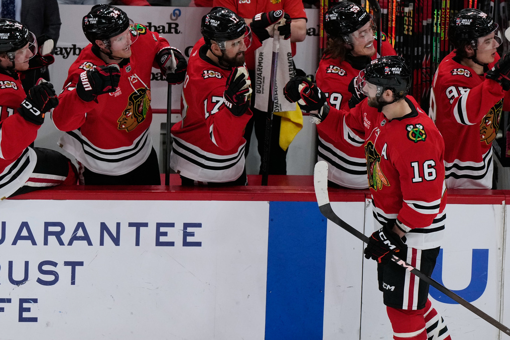 Chicago Blackhawks center Jason Dickinson (16) celebrates with teammates after scoring during the second period of an NHL hockey game against the Winnipeg Jets in Chicago, Monday, Jan. 19, 2026. (AP Photo/Nam Y. Huh)