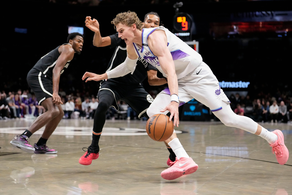 Utah Jazz forward Lauri Markkanen, front, drives past Brooklyn Nets forward Ziaire Williams (1) during the first half of an NBA basketball game, Thursday, Dec. 4, 2025, in New York. (AP Photo/Yuki Iwamura)