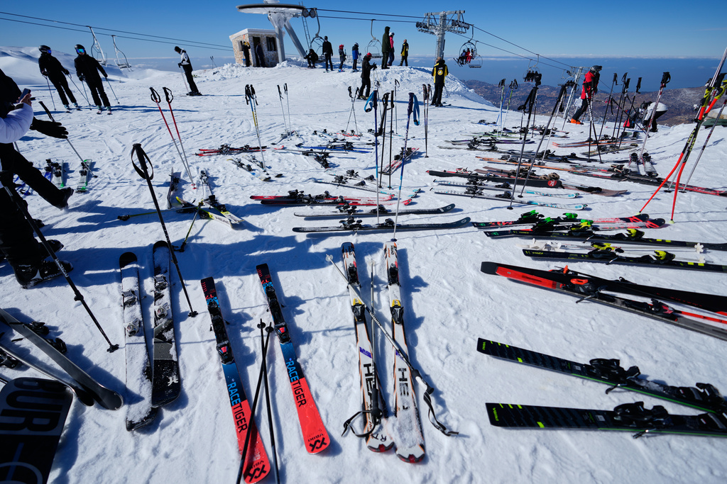 Skis and poles are left on the snow as skiers take a break at the Mzaar-Kfardebian ski resort northeast of Beirut, Lebanon, Saturday, Jan. 3, 2026. (AP Photo/Hassan Ammar)