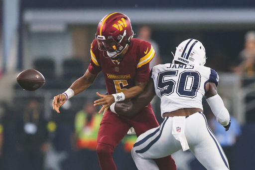 Dallas Cowboys linebacker Shemar James (50) forces a fumble by Washington Commanders quarterback Jayden Daniels (5) during the second half of an NFL football game Sunday, Oct. 19, 2025, in Arlington, Texas. (AP Photo/Gareth Patterson) Dallas Cowboys linebacker Shemar James (50) forces a fumble by Washington Commanders quarterback Jayden Daniels (5) during the second half of an NFL football game Sunday, Oct. 19, 2025, in Arlington, Texas. (AP Photo/Gareth Patterson)