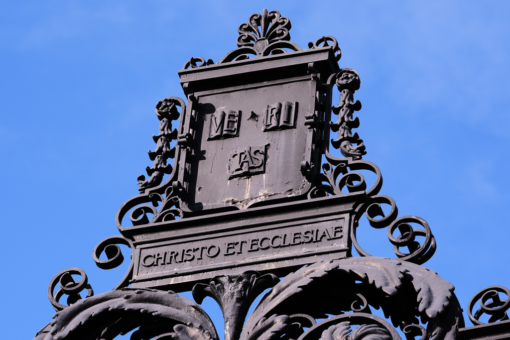 The Harvard University logo is displayed on a metal gate leading to Harvard Yard at Harvard University, Tuesday, Sept. 30, 2025, in Cambridge, Mass. (AP Photo/Charles Krupa)