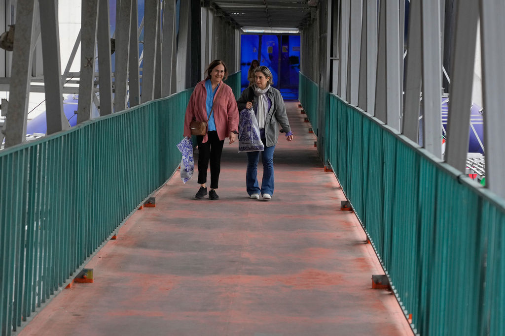 Women walk across an overpass in downtown Tehran, Iran, Tuesday, Feb. 24, 2026. (AP Photo/Vahid Salemi)