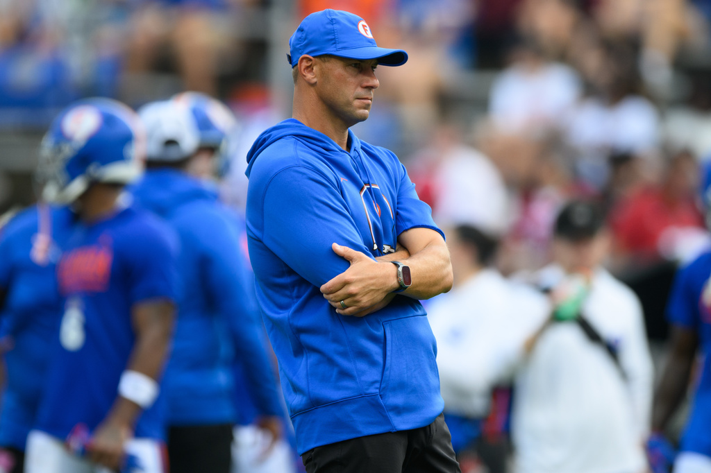 Florida head coach Jon Sumrall watches his team warm up before an NCAA college football game against South Carolina, Saturday, Oct. 10, 2026, in Gainesville, Fla. (AP Photo/Noah Lantor)